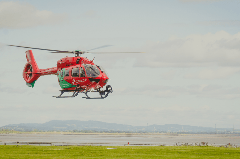 Helicopter flying into Cardiff airbase with sea in background